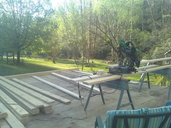 Miter saw and framing lumber on a deck under construction in Joseph City